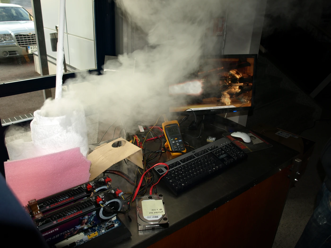 SF3D overclocking bench with dual Radeon graphics cards and a multimeter reading sub-zero temperatures